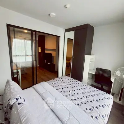 Modern bedroom with mirrored wardrobe and sliding glass doors