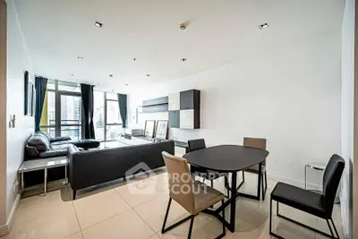 Spacious modern living room with sleek furniture and city view.