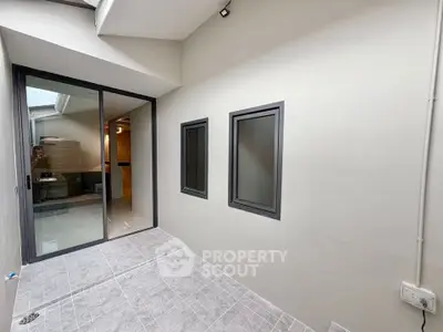 Modern interior space with sliding glass doors and tiled flooring, ideal for versatile use.