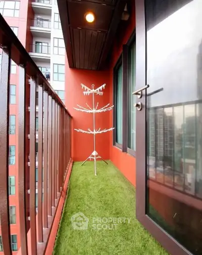 Charming balcony with artificial grass and city view, perfect for relaxation.