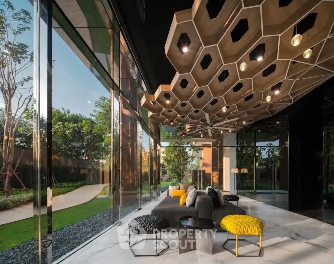 Luxurious modern living room with unique ceiling design and large glass windows overlooking a lush garden.