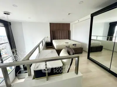 Modern loft bedroom with large mirror and city view, featuring stylish furniture and elegant design.