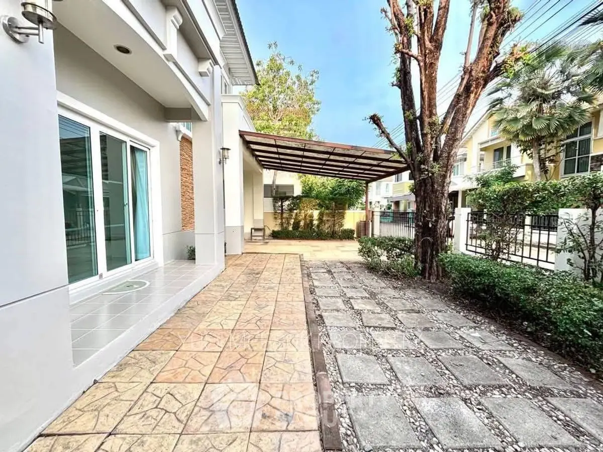 Spacious modern home with covered patio and landscaped garden in serene neighborhood.