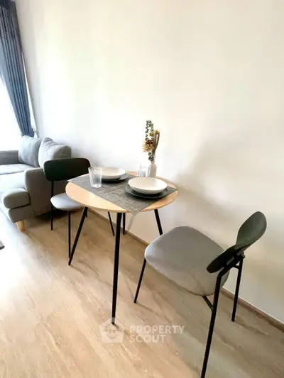 Cozy living room with modern dining setup and natural light