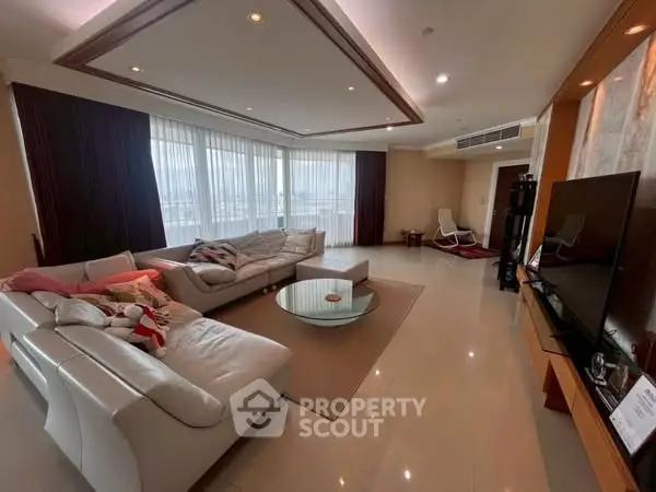 Spacious modern living room with large windows and stylish furniture