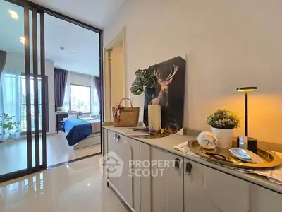 Stylish modern apartment entrance with elegant decor leading to a cozy bedroom with natural light.
