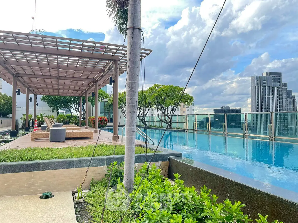 Luxurious rooftop pool with stunning city views and modern lounging area.