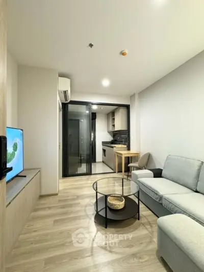 Modern living room with sleek design and open kitchen layout