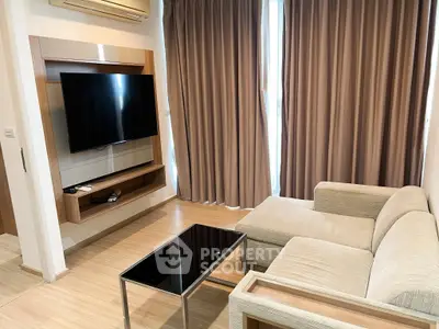 Modern living room with sleek TV setup and cozy beige sofa, perfect for relaxation.