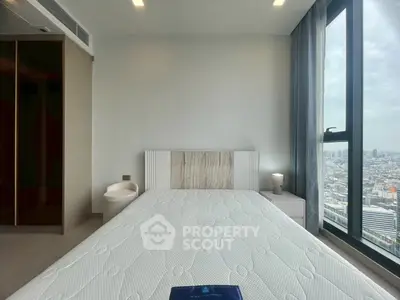 Modern bedroom with city view and stylish decor in high-rise apartment