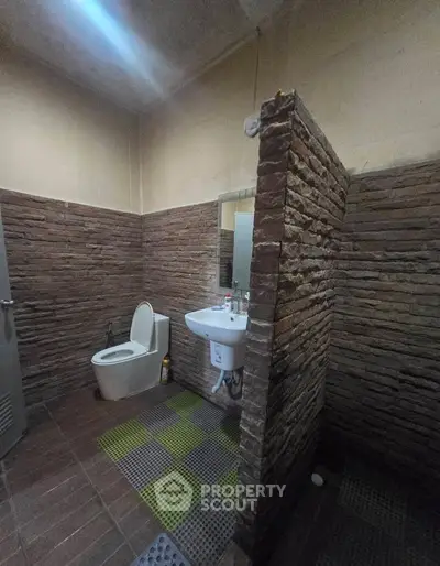 Rustic bathroom with stone walls and modern fixtures