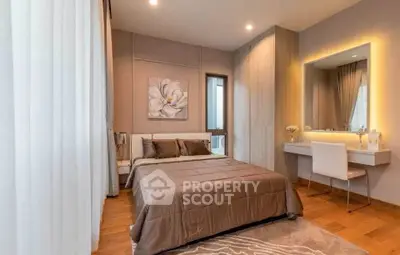 Elegant bedroom with modern decor, featuring a cozy bed, stylish vanity, and warm lighting.