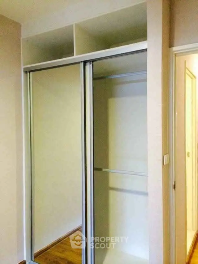 Spacious built-in closet with sliding doors in modern apartment