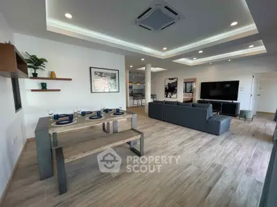 Spacious modern living room with open dining area and stylish decor
