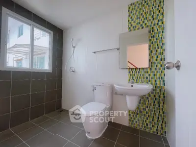 Spacious modern bathroom with stylish tile accents and natural light