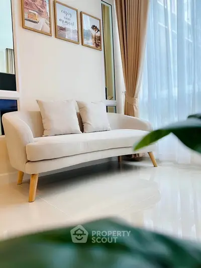 Elegant living room with cozy beige sofa and stylish decor, perfect for modern urban living.