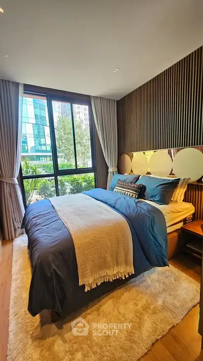 Luxurious bedroom with modern decor and large window view