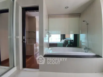 Modern bathroom with bathtub and glass partition in luxury apartment