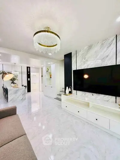Luxurious modern living room with marble floors and elegant chandelier