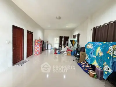 Spacious living room with glossy tile flooring and natural light, ideal for customization.