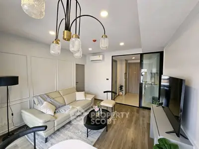 Modern living room with elegant lighting and stylish decor in a contemporary apartment.