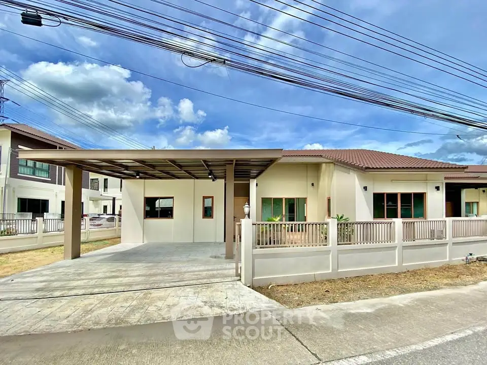 Charming single-story house with carport and fenced yard in a serene neighborhood.
