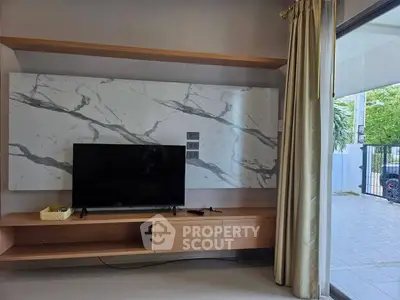 Modern living room with marble accent wall and sleek TV setup