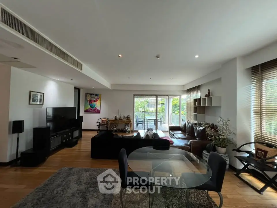 Spacious modern living room with large windows and stylish decor, perfect for relaxation and entertainment.