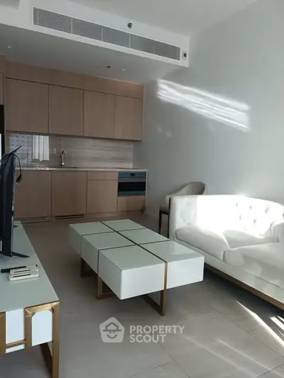 Modern living room with sleek kitchen and stylish furniture