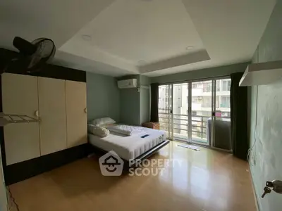 Spacious bedroom with balcony access and ample natural light.