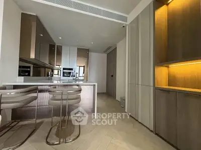 Modern kitchen with sleek cabinetry and built-in appliances in a luxury apartment.