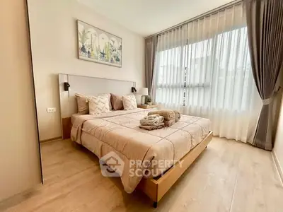 Elegant bedroom with natural light and modern decor, featuring cozy bedding and stylish curtains.