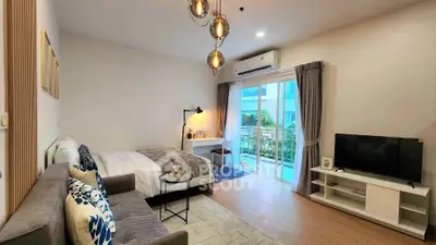 Modern studio apartment with cozy living area and balcony view