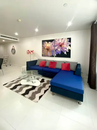 Modern living room with stylish blue sectional sofa and vibrant decor