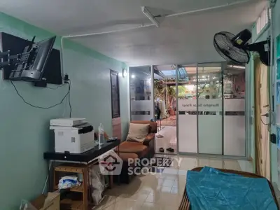 Cozy living room with modern amenities and garden view, perfect for relaxation and entertainment.