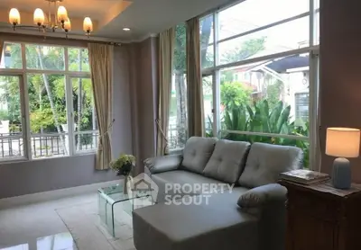 Spacious living room with large windows and modern decor