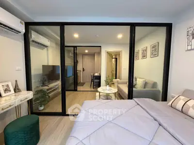 Modern studio apartment with glass partition, cozy living area, and stylish decor.