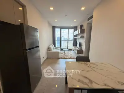 Modern apartment interior with open layout, featuring a cozy living area and stylish kitchen.