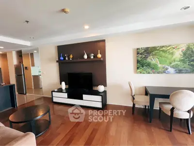 Spacious living room with modern decor and wooden flooring in a stylish apartment.