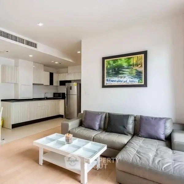 Modern living room with sleek kitchen and stylish decor