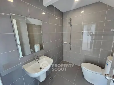 Modern bathroom with sleek gray tiles and contemporary fixtures
