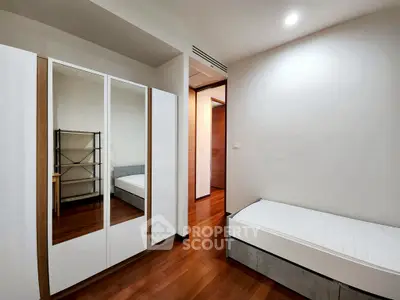 Modern bedroom with wooden flooring and minimalist furniture design