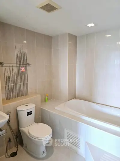 Modern bathroom with sleek bathtub and stylish tile design