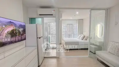 Modern apartment interior with open layout, featuring a cozy living room and elegant bedroom with balcony view.