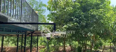 Charming outdoor view with lush greenery and modern balcony, perfect for nature lovers.