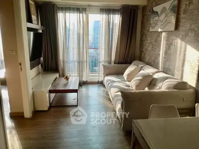 Stylish living room with modern decor and large windows offering city views, perfect for urban living.