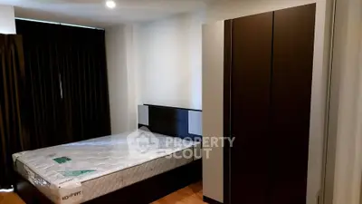 Modern bedroom with sleek wardrobe and comfortable bed in stylish apartment.