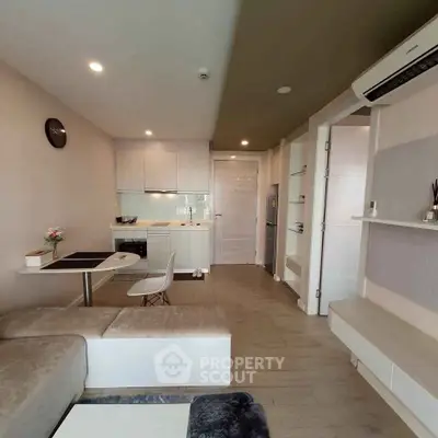 Modern compact living room with open kitchen and stylish decor