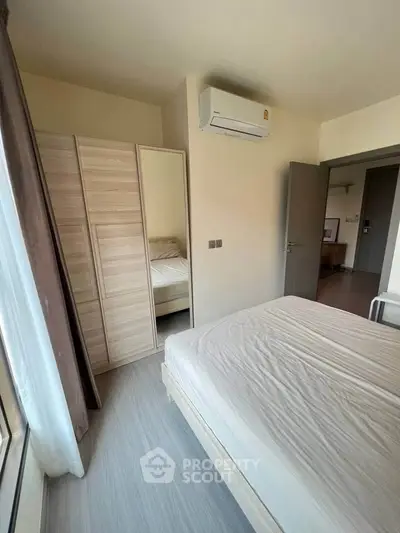 Modern bedroom with air conditioning and wardrobe in a bright apartment