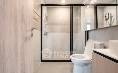 Modern bathroom with glass shower enclosure and sleek fixtures